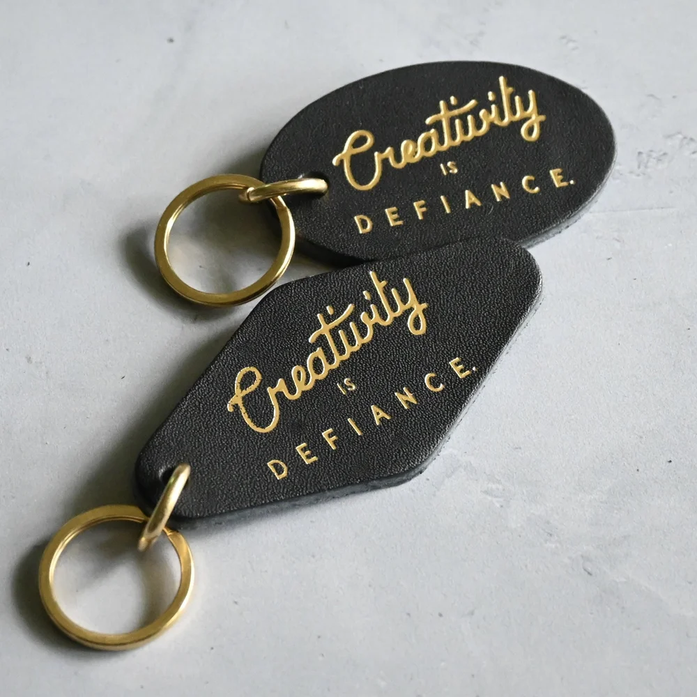 Handmade leather keychain with modern swearing affirmations and